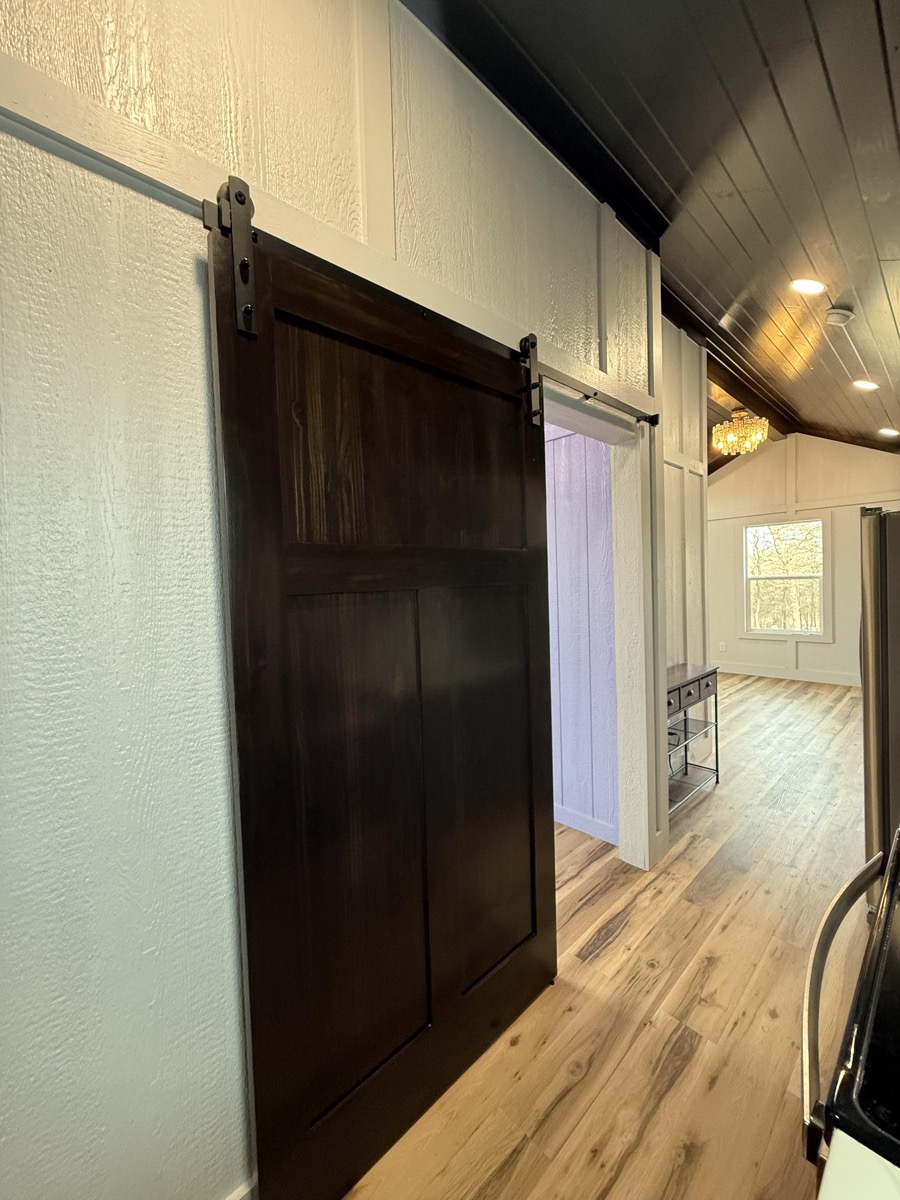 Kitchen storage and cabinetry details in Barn Brothers custom tiny home build