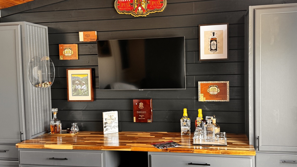 Black shiplap accent wall with TV and cigar box decorations