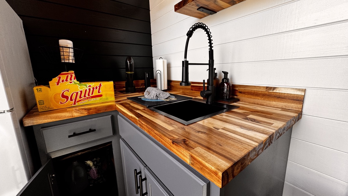 Tiger-striped butcher block countertop with black sink and modern faucet