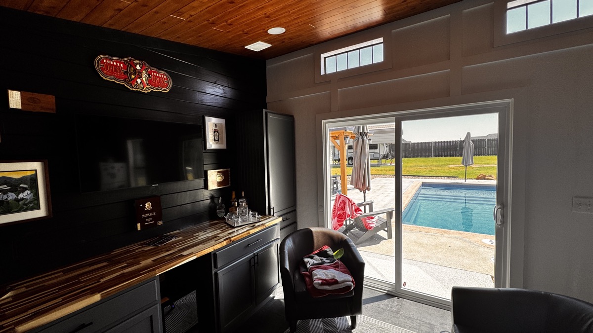 The Oasis interior with pool view, cigar lounge bar and warm wood ceiling