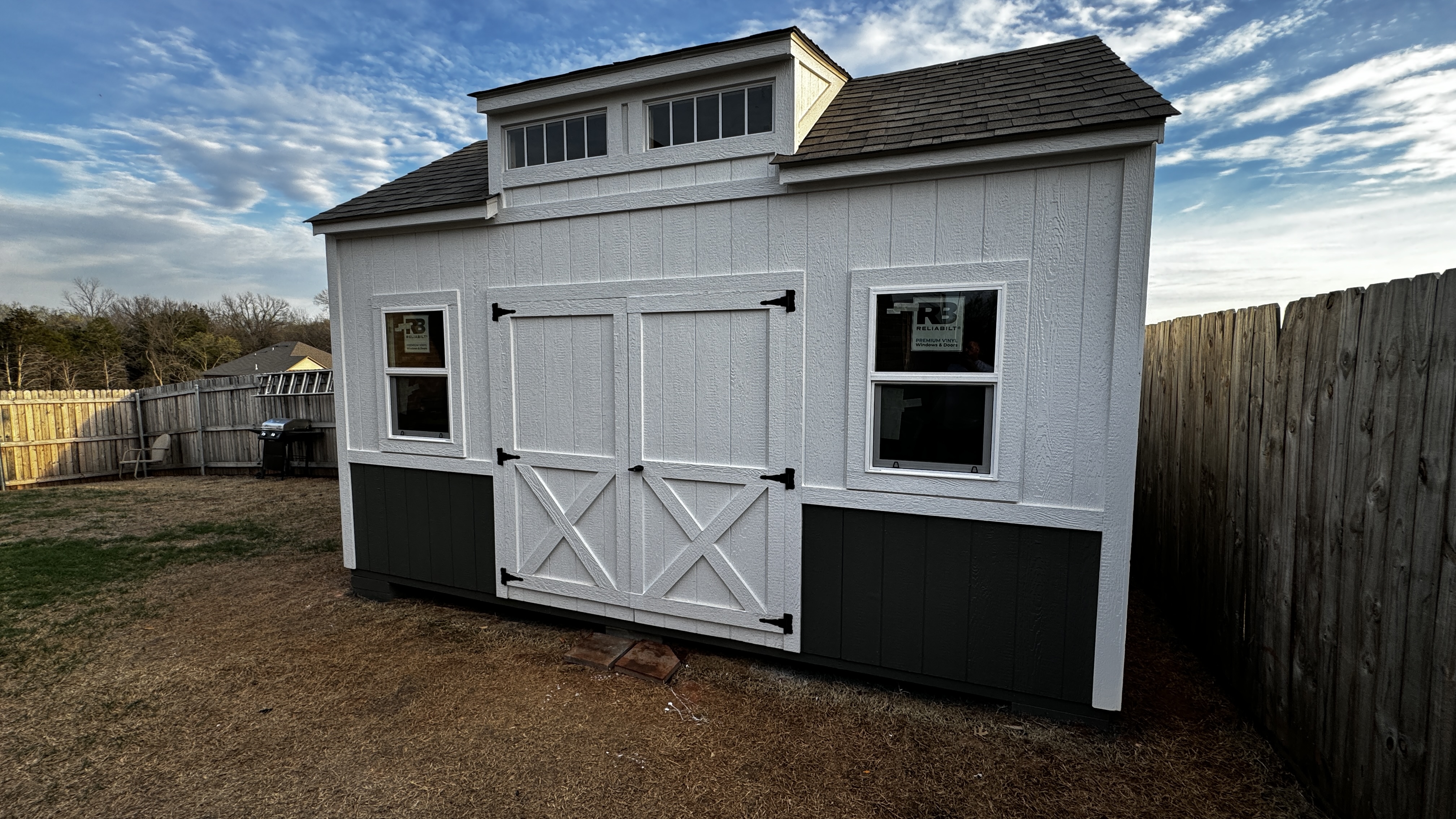 White dormer shed with black accents by Barn Brothers